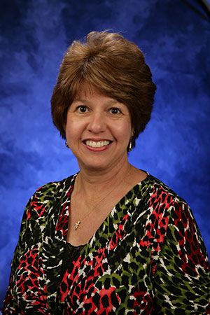 A head-and-shoulders professional photo of Aida Wilkinson
