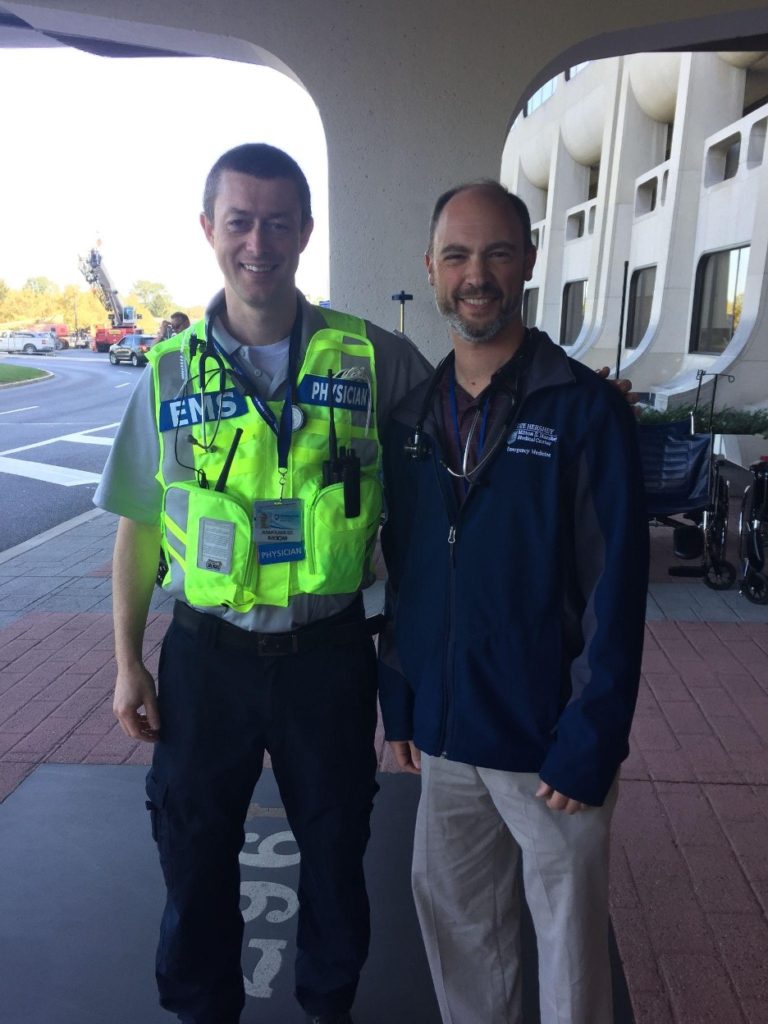 Dr. Avram Flamm and Dr. Jeffrey Lubin, both EMS fellowship faculty members, post for a photo outside the Penn State College of Medicine crescent building.