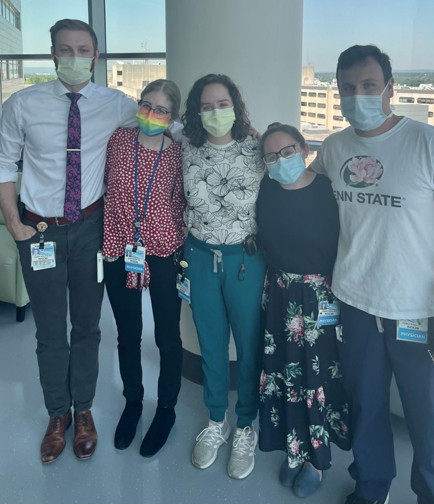 Five residents in face masks pose in the medical center 